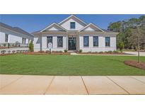 Beautifully landscaped front yard with a lush lawn and a charming white brick home at 123 Candler Loop, Acworth, GA 30101
