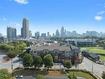 Stunning aerial view of the condominium complex with a backdrop of the city skyline and lush green surroundings at 400 17Th Nw St # 2218, Atlanta, GA 30363
