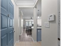 Welcoming entryway featuring a blue front door and leading to a living room with stylish decor and wood floors at 400 17Th Nw St # 2218, Atlanta, GA 30363