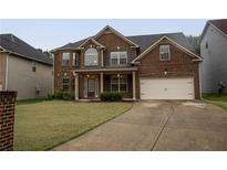 Charming two-story brick home with well-maintained lawn and a two-car garage at 4349 Sublime Trl, Atlanta, GA 30349