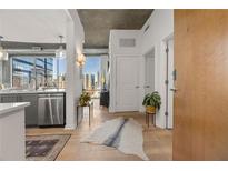 Bright, open living space with wood floors, city views, and stainless steel appliances at 923 Peachtree Ne St # 939, Atlanta, GA 30309