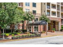 Inviting condo building entrance with covered awning and manicured landscaping at 1101 Juniper Ne St # 612, Atlanta, GA 30309