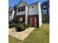 Charming two-story home with red brick accents and a well-manicured front yard at 257 Brookview Dr, Riverdale, GA 30274