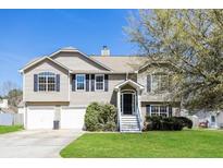 Charming two-story home with a well-maintained lawn, a two-car garage, and beautiful curb appeal at 10670 Day Lily Dr, Hampton, GA 30228