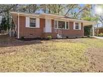 Charming brick home with a well-manicured lawn and covered porch, showcasing classic curb appeal at 1207 Ellington Dr, Morrow, GA 30260