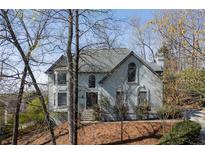 Charming two-story home with well-manicured lawn and mature trees at 10660 Thatcher Way, Johns Creek, GA 30097