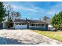 Charming single story home featuring an attached garage, a front porch, and a paved driveway at 11555 Brown Bridge Rd, Covington, GA 30016