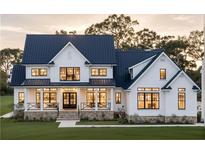 Stunning two-story home featuring a modern farmhouse design, a well-manicured lawn, and a welcoming front porch at 152 Sherwood Ln, Canton, GA 30115