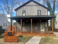Charming craftsman-style home with a welcoming front porch and modern gray siding at 1031 Camilla Sw St, Atlanta, GA 30314