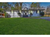 Charming single-story home featuring a well-manicured lawn and a classic brick facade at 3001 Will Rogers Se Pl, Atlanta, GA 30316