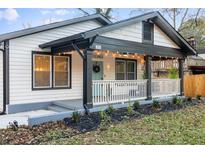 Charming home featuring a covered porch with string lights and a welcoming front door at 503 Mcwilliams Se Rd, Atlanta, GA 30315
