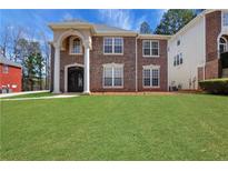 Charming two-story brick home with a well-manicured lawn at 3485 Walnut Rdg, Atlanta, GA 30349