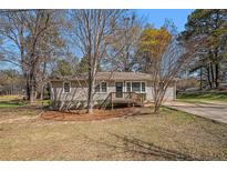 Charming single-story home featuring a well-maintained lawn and a quaint front porch at 10164 Sunny Sw Dr, Covington, GA 30014