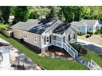 Charming bungalow with a manicured lawn and inviting front porch at 1615 Orlando Sw St, Atlanta, GA 30311