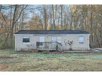 Single story home featuring a front porch with siding, surrounded by trees and an ample front yard at 355 Double D Rd, Temple, GA 30179