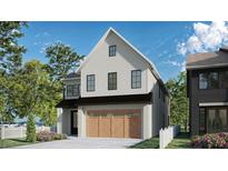 Charming two-story home with white siding, black trim, and a two-car garage with decorative wood doors at 2595 Apple Valley Rd, Brookhaven, GA 30319