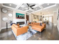Spacious living room with a fireplace, modern sectional sofa, and an open floor plan at 1110 Briar Cove Cir, Atlanta, GA 30329