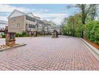 Gated townhome community featuring brick facade and professionally landscaped grounds at 2022 Raven Way, Atlanta, GA 30341