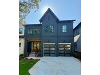 Two-story home featuring a modern design, two-car garage, and a well-manicured lawn at 2591 Apple Valley Rd, Brookhaven, GA 30319