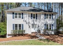 Charming two-story home featuring white siding, blue shutters, and a well-manicured front yard at 1069 Colony Cir, Marietta, GA 30068