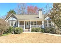 Charming single-Gathering home featuring a stone facade, a covered porch, and well-manicured landscaping at 189 Meadow Spring Dr, Temple, GA 30179