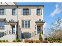 Charming townhome with a light brick facade, neat landscaping, and inviting front porch at 1949 Skyfall Cir, Brookhaven, GA 30319