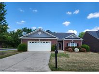 Charming one-story brick home with a two-car garage and beautifully landscaped front yard at 1705 Rolling View Dr, Cumming, GA 30040