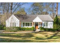 Charming single-story home with a manicured lawn, inviting front porch, and mature trees in a desirable neighborhood at 1760 Helen Ne Dr, Atlanta, GA 30306