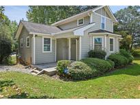 Charming two-story home with a front porch, beautiful bay window, and well-manicured landscaping at 1800 E Lake Rd, Mcdonough, GA 30252