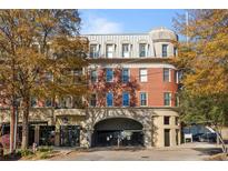 Elegant multi-story building featuring classic brickwork, arched entryway and upper level dormer windows at 560 Dutch Valley Rd # 2313, Atlanta, GA 30324