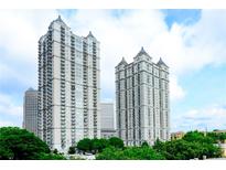 Stunning exterior view of two high-rise condo buildings with manicured landscaping and blue skies at 195 14Th Ne St # 2402, Atlanta, GA 30309