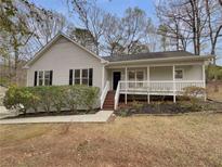 Charming one-story home with a inviting front porch and well maintained landscaping at 87 Leaf Lake Dr, Suwanee, GA 30024