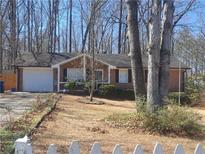 Charming brick ranch-style home with an attached garage and well-kept front yard at 359 Cedar Ridge Trl, Lawrenceville, GA 30046