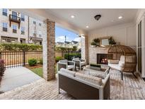 Charming covered patio with brick fireplace and ample seating, perfect for relaxing outdoors at 520 Clover Ln, Alpharetta, GA 30009