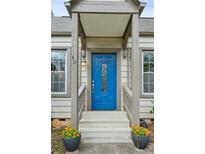 Inviting entryway featuring a vibrant blue door and decorative potted plants for added curb appeal at 49 Wyman Se St, Atlanta, GA 30317