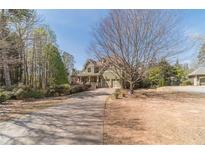 Charming two-story home featuring an attached two-car garage and a long private driveway at 3828 Morning Meadow Ln, Buford, GA 30519