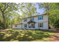 Charming two-story home with a well-manicured lawn and beautiful landscaping, perfect for suburban living at 4446 Huntington Cir, Atlanta, GA 30338