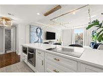 Bright kitchen featuring a modern island, stainless appliances, and beautiful lighting, perfect for cooking and entertaining at 130 26Th Nw St # 807, Atlanta, GA 30309