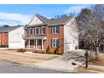 Charming two-story home featuring a classic brick facade, black shutters and a well-manicured lawn at 2517 Hampton Park Ct, Marietta, GA 30062
