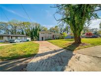 Charming home featuring a well-maintained lawn, long driveway, and lush greenery at 2628 Miriam Ln, Decatur, GA 30032