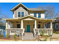 Charming two-story home featuring a large front porch and a vibrant turquoise front door at 1503 Westwood Sw Ave, Atlanta, GA 30310