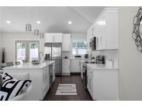 Bright, white kitchen with stainless steel appliances, pendant lighting, and an island at 1882 Rosewood Rd, Decatur, GA 30032