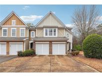 Charming townhome featuring a two-car garage and a well-manicured front yard at 2026 Ellison Nw Way # 13, Kennesaw, GA 30152