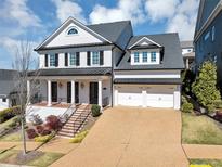 Stunning two-story white brick home with a two-car garage and beautiful landscaped front yard at 3020 Barnes Mill Ct, Roswell, GA 30075