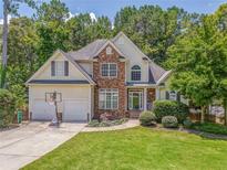 Charming two-story home with stone accents, a well-manicured lawn, and a two-car garage at 119 Creekside Vw, Hiram, GA 30141