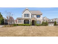Charming two-story home featuring manicured landscaping, a stone-accented entrance, and neutral siding at 2564 Lulworth Ne Ln, Marietta, GA 30062