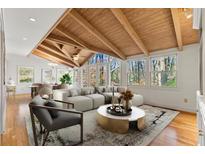 Bright living room with vaulted wood ceiling, large windows, and elegant furnishings overlooking the lush outdoors at 1051 Lakeshore Dr, Avondale Estates, GA 30002