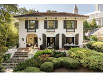 Charming stucco two-story home with black shutters, wrought iron accents, and professional landscaping at 31 Lafayette Ne Dr, Atlanta, GA 30309