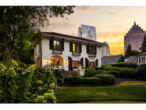 Stunning two-story home with manicured landscaping and a picturesque city view at sunset at 31 Lafayette Ne Dr, Atlanta, GA 30309