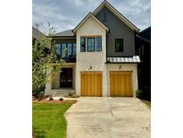 Charming two-story home featuring a modern design with a mix of painted brick and gray siding at 2583 Apple Valley Rd, Brookhaven, GA 30319